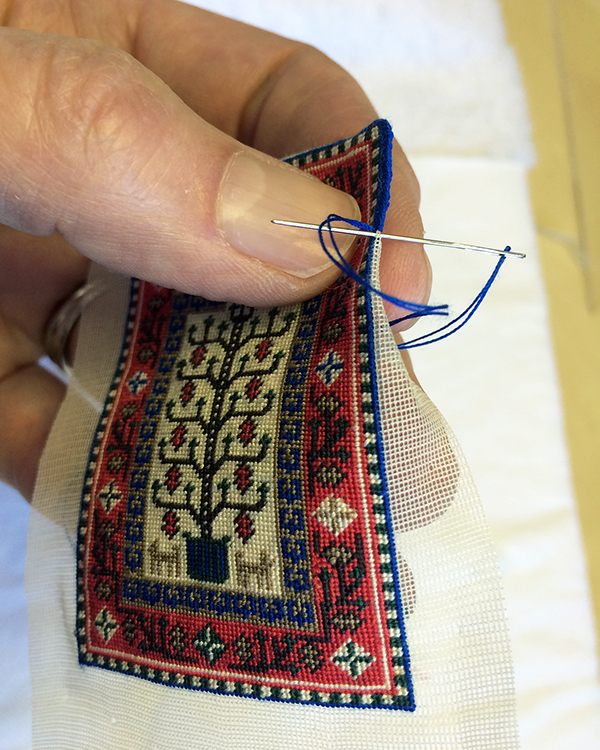 Binding the edges, with scary dinosaur fingers